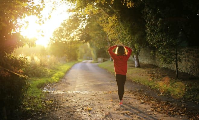 woman walking on pathway during daytime