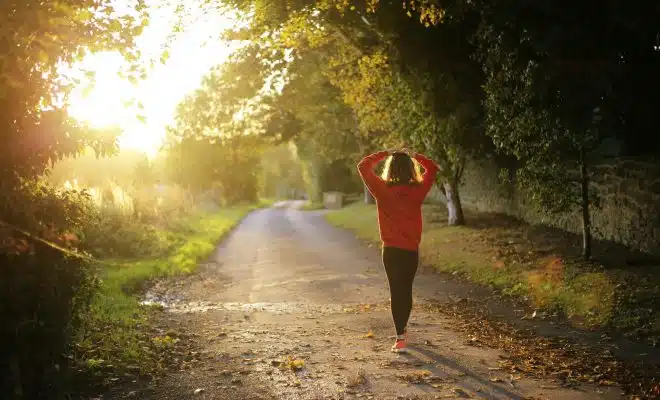 woman walking on pathway during daytime